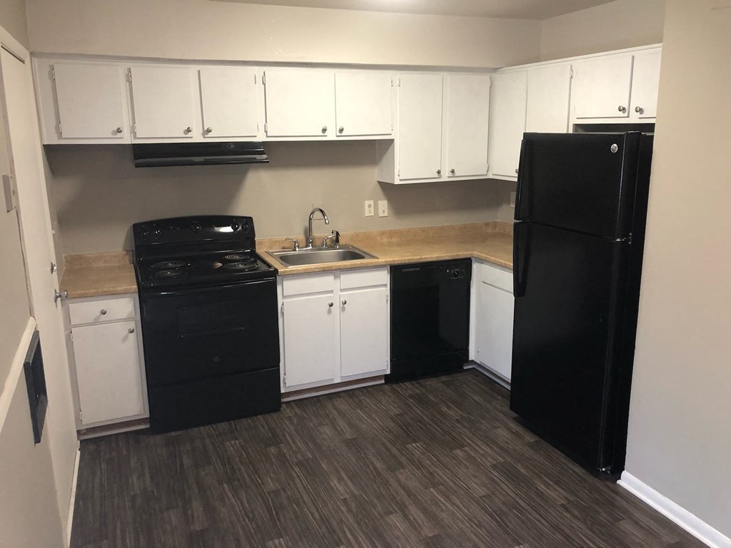 a kitchen with black appliances and white cabinets