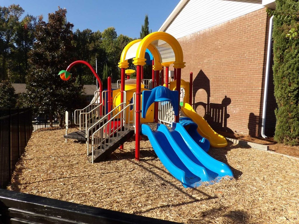 a playground at a school with a blue slide
