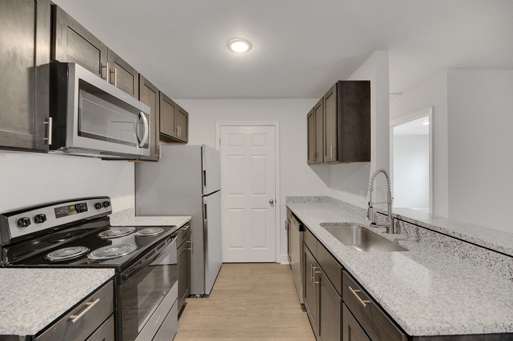 a kitchen with granite counter tops and stainless steel appliances