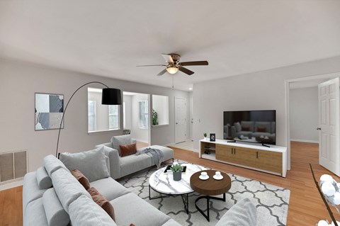 A living room with a grey couch and a television.