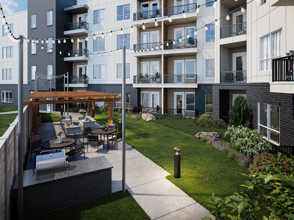 an outdoor patio with tables and chairs at an apartment building
