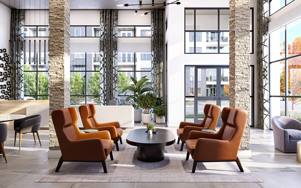 the lobby of a hotel with chairs and a table