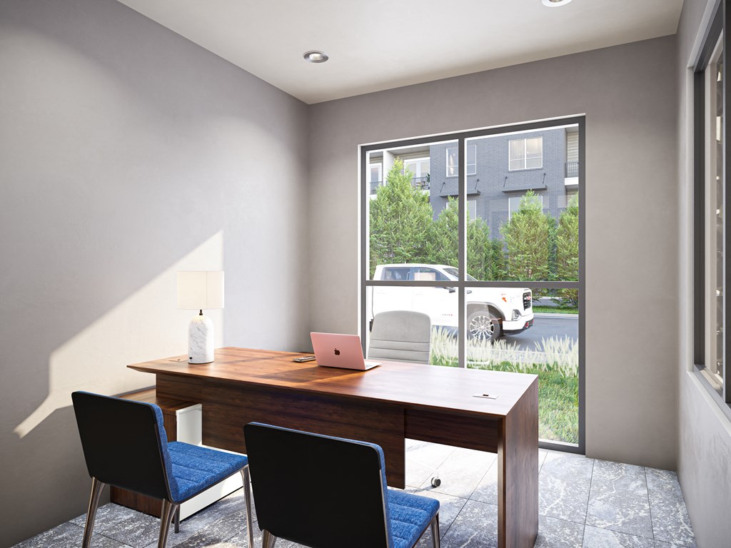 a home office with a large window and a desk with a laptop