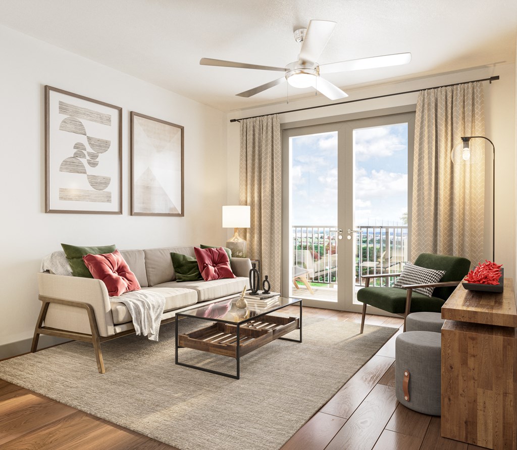 a living room with a couch and a chair and a ceiling fan