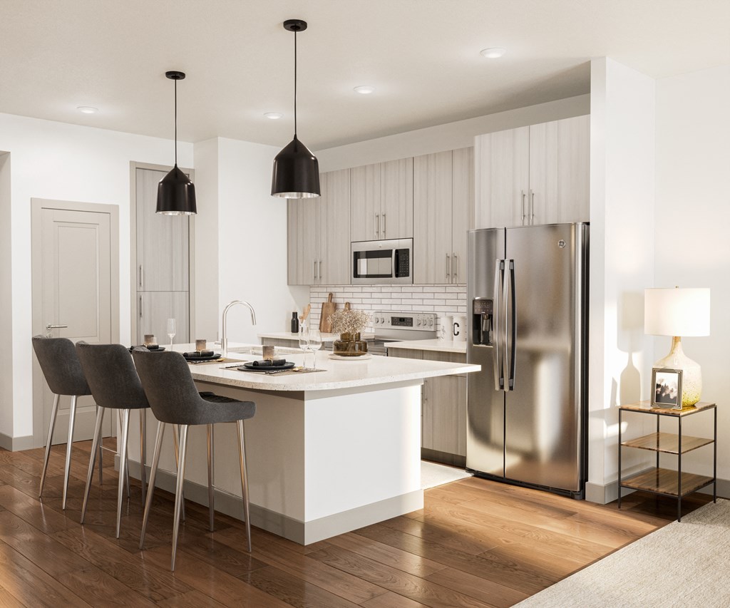 a kitchen with white cabinets and a white island with chairs