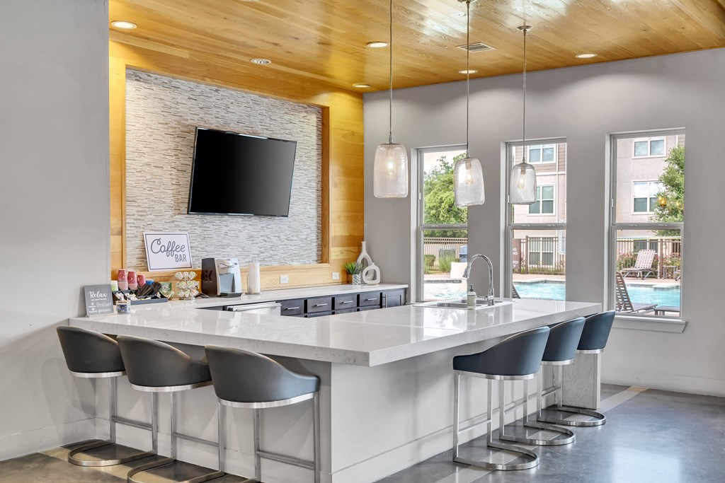 a kitchen with a large island and a tv on the wall