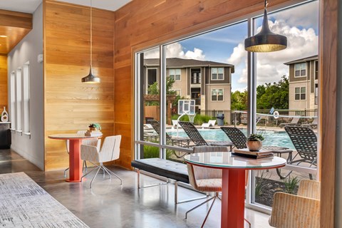 a dining area with tables and chairs next to a pool