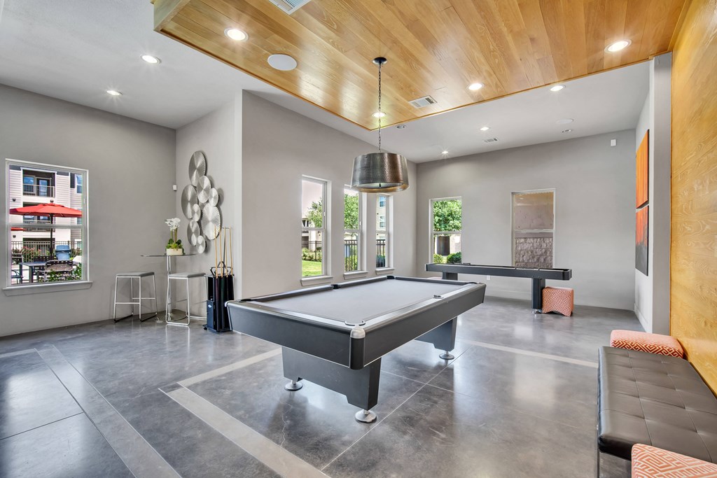 a game room with a pool table and a ping pong