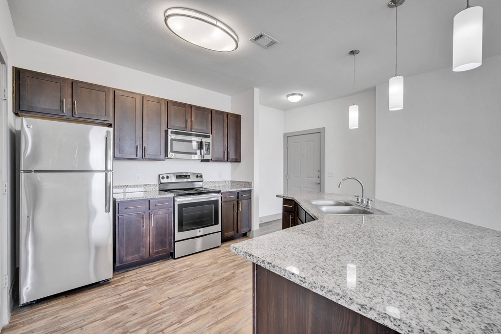 a kitchen with stainless steel appliances and a granite counter top