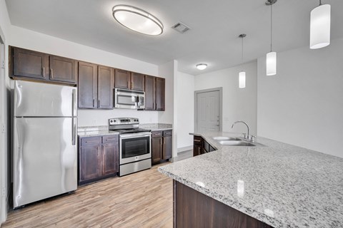 a kitchen with stainless steel appliances and a granite counter top