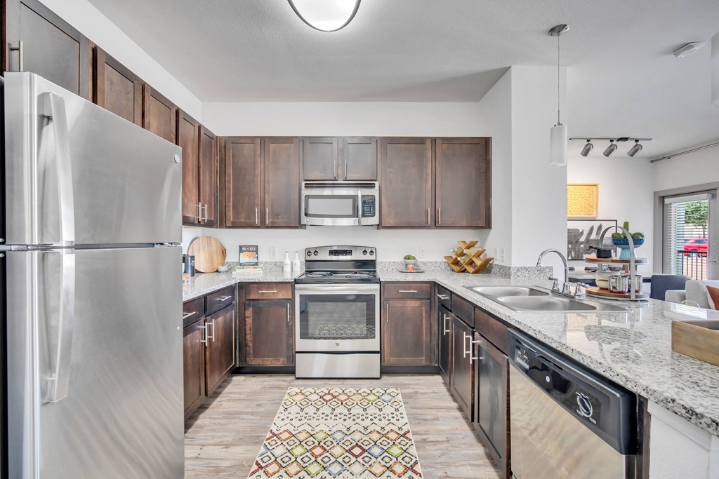 a kitchen with wooden cabinets and stainless steel appliances