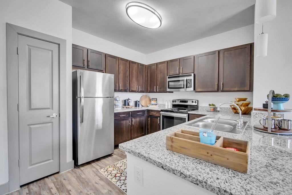 a kitchen with stainless steel appliances and granite counter tops