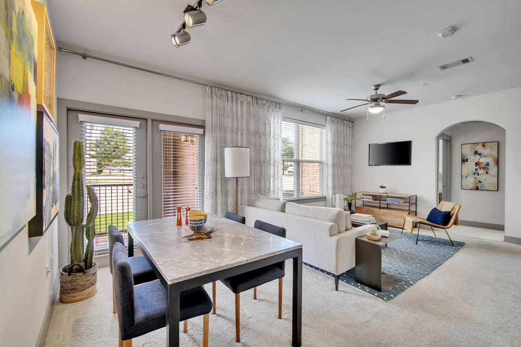 a living room with a dining room table and a couch