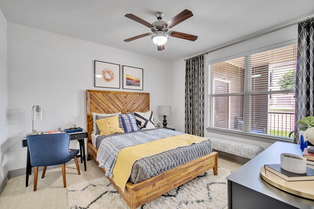 a bedroom with a bed and a ceiling fan