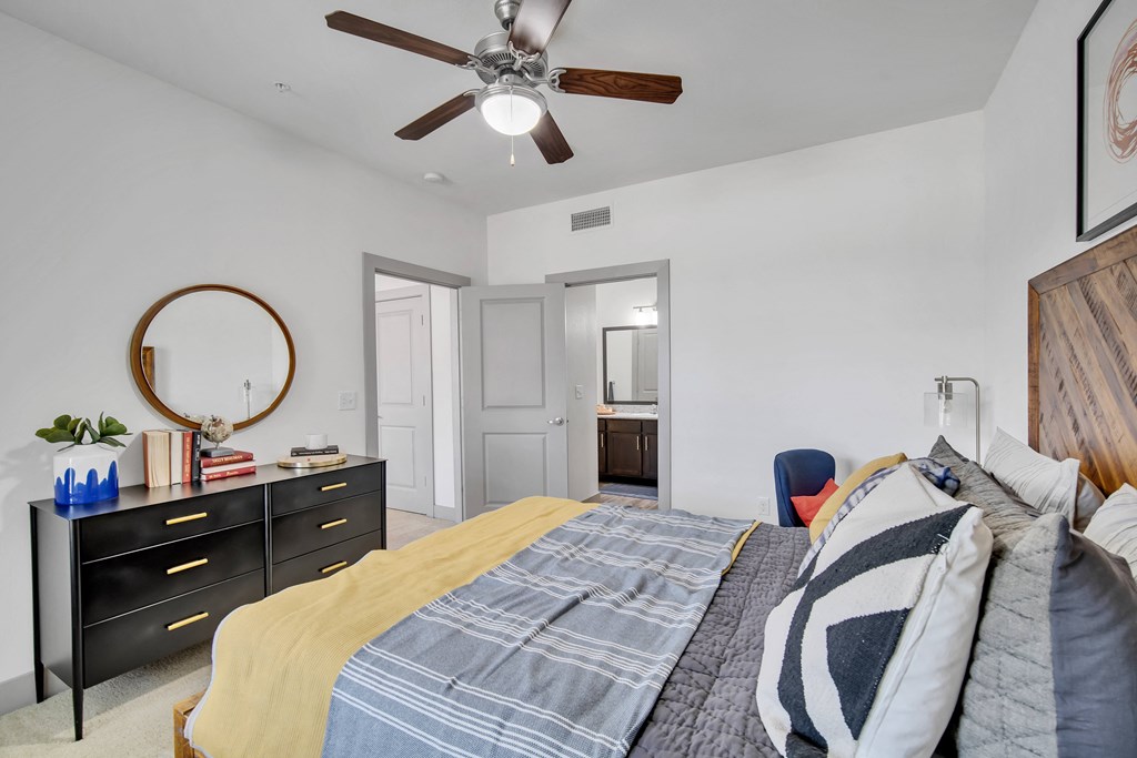 a bedroom with a bed and a ceiling fan