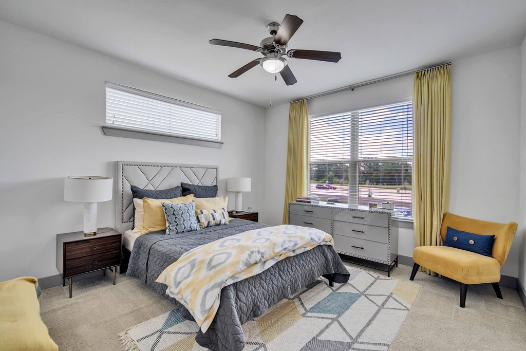a bedroom with a bed and a ceiling fan