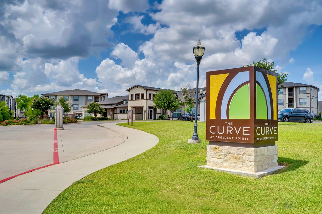 the cure care sign in front of apartments
