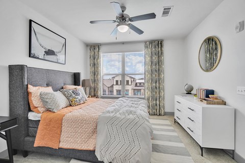 a bedroom with a bed and a ceiling fan