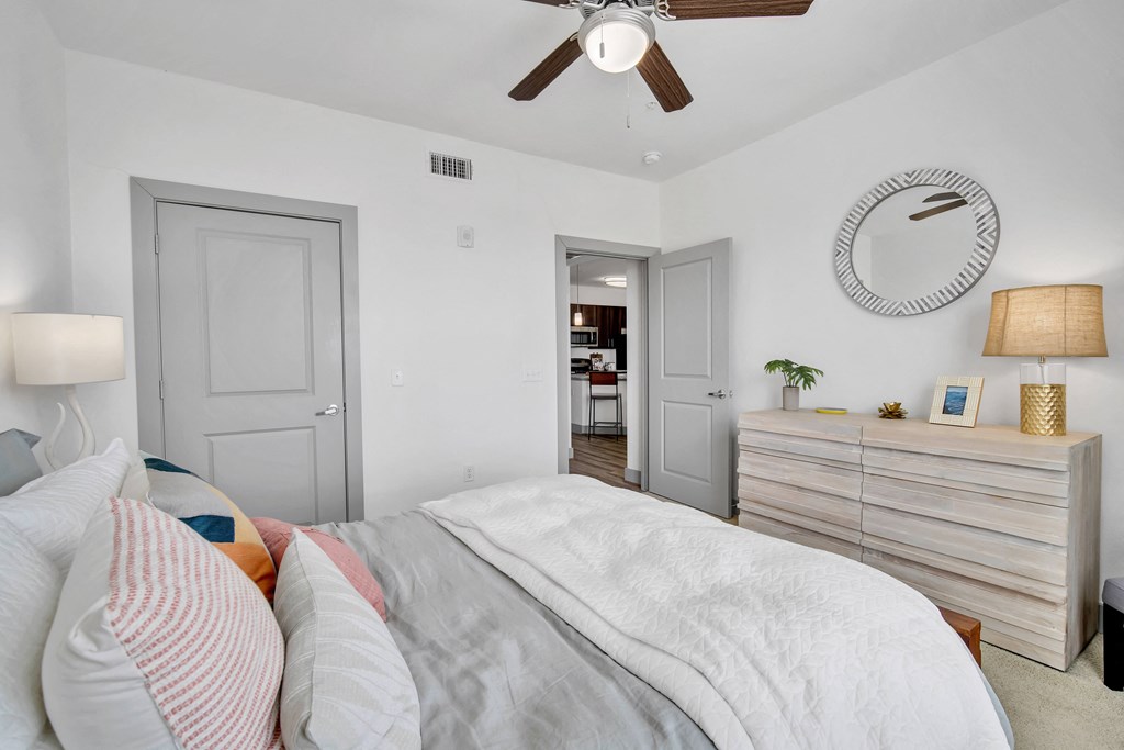 a bedroom with a large bed and a ceiling fan