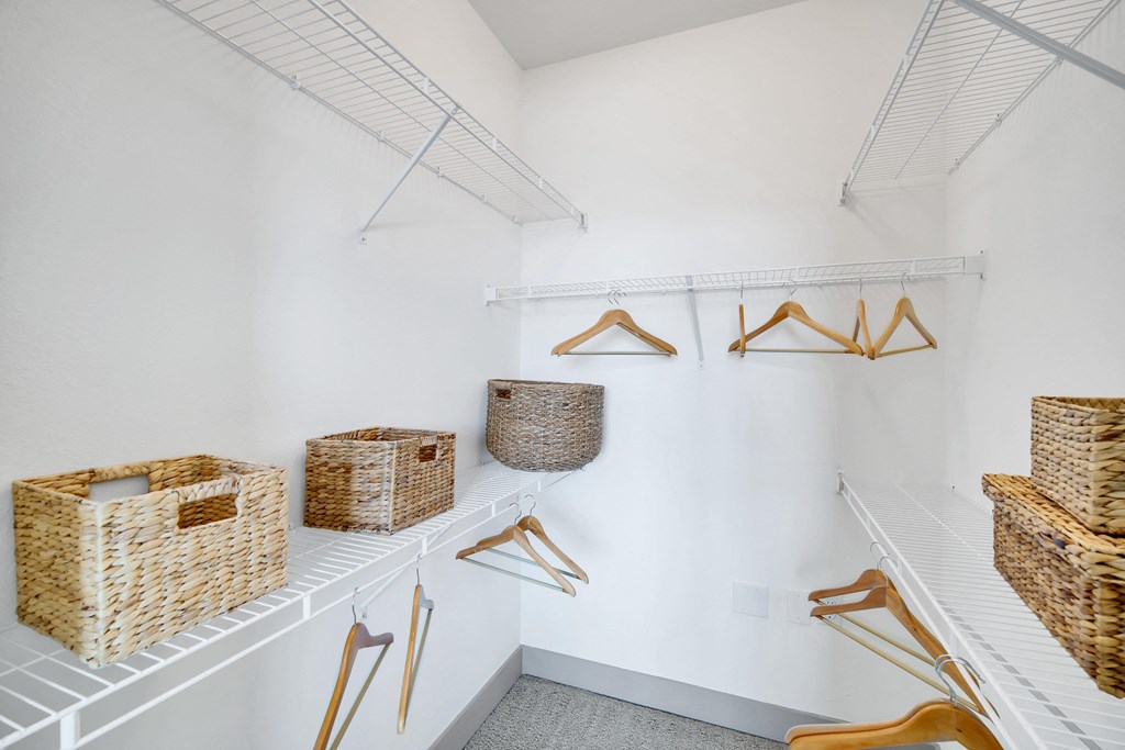 a room with baskets and hangers on the wall