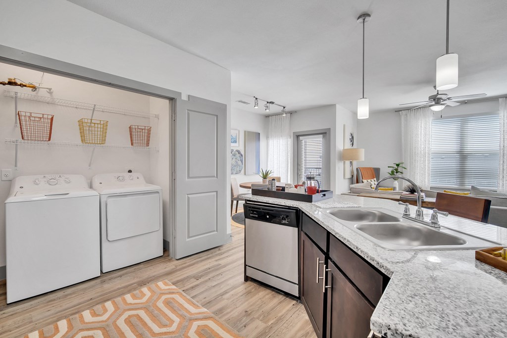 an open kitchen with a washer and dryer and a laundry room