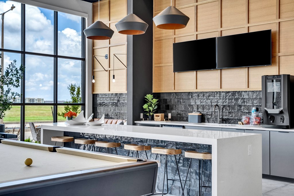 a kitchen with a large window and a table with chairs