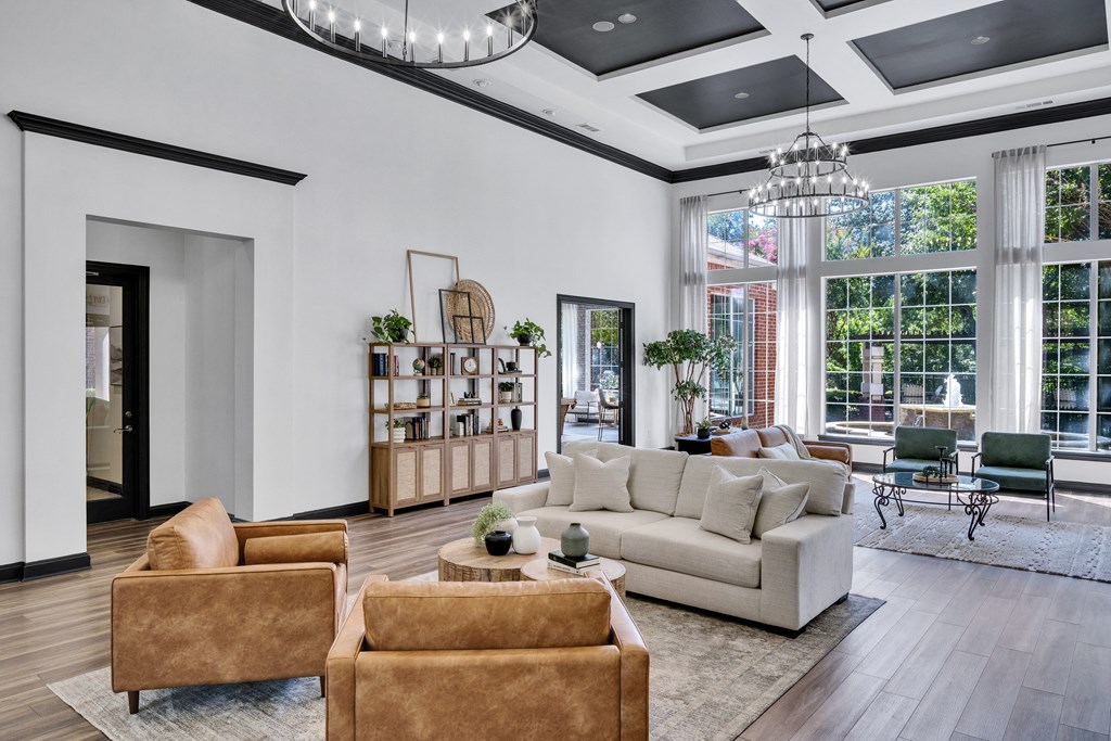 a living room with couches and chairs and a large window