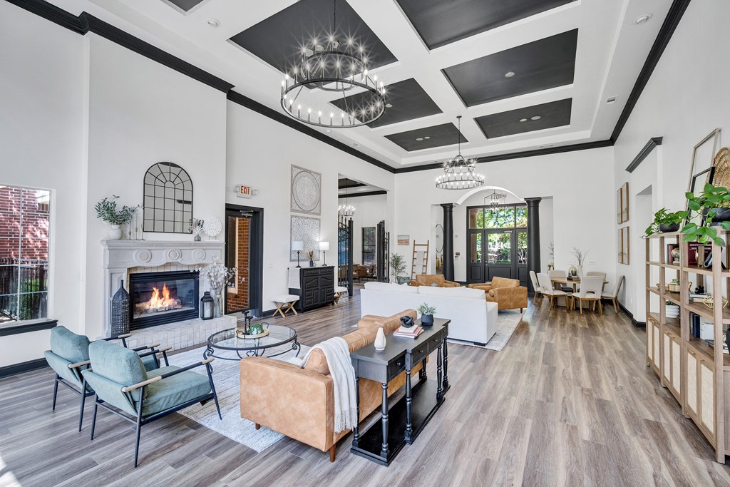 the living room has a fireplace and couches and a table with chairs