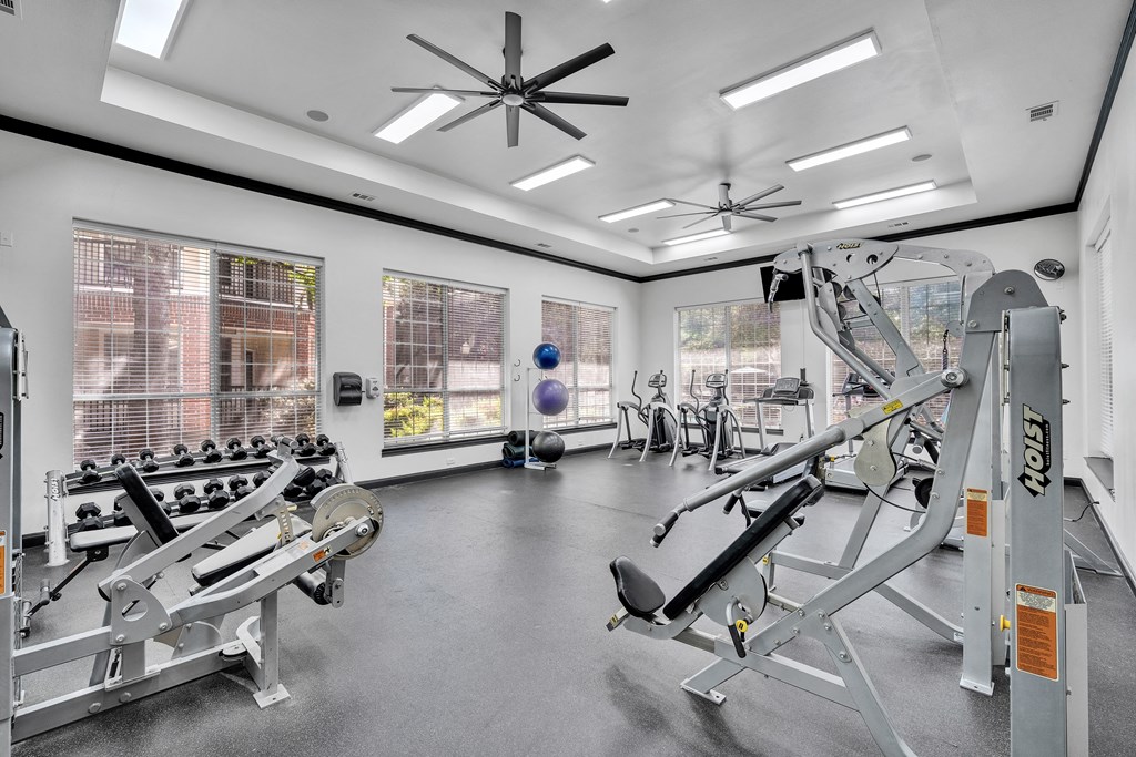 a gym with weights and other exercise equipment and windows