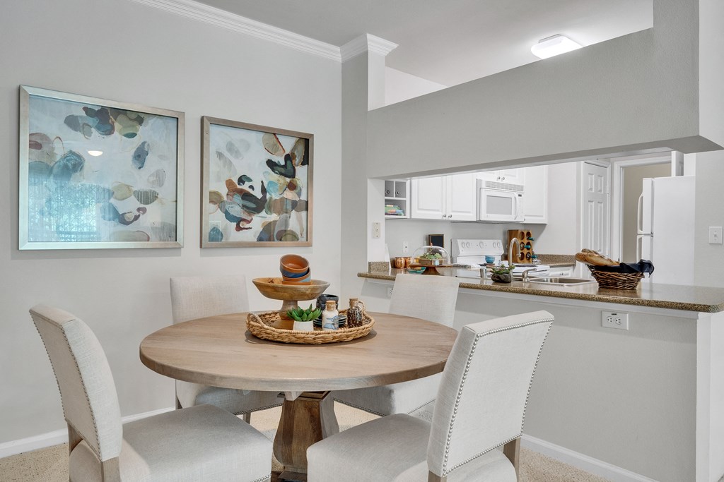 an open kitchen and dining room with a table and chairs