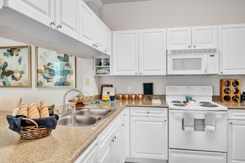 a kitchen with white appliances and a counter top