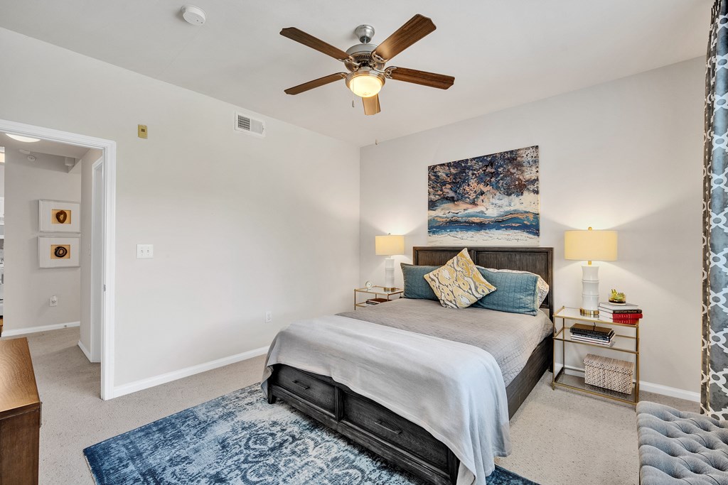 a bedroom with a bed and a ceiling fan