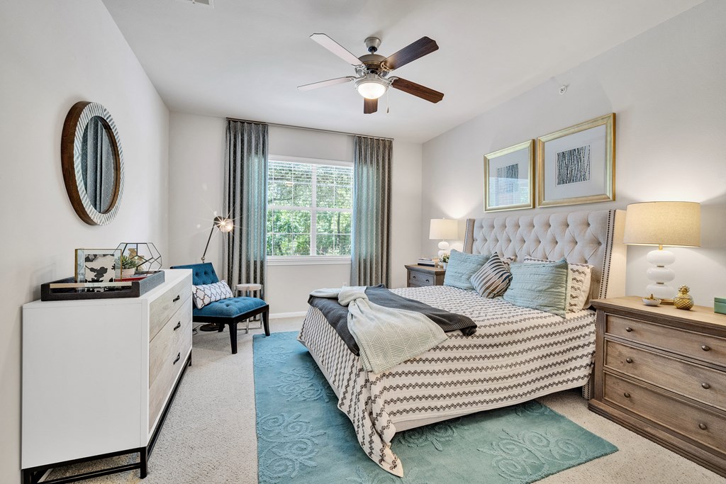 a bedroom with a bed and a ceiling fan