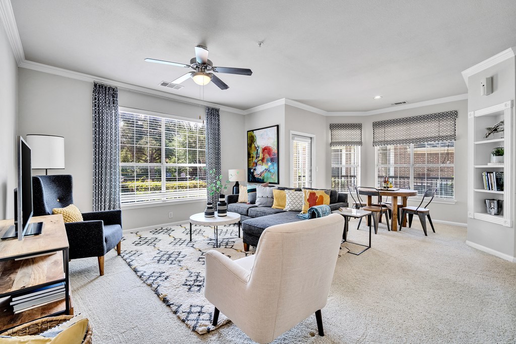 a living room with furniture and a ceiling fan