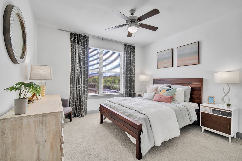 a bedroom with a bed and a ceiling fan