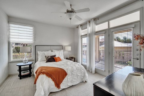 a bedroom with a large bed and a ceiling fan