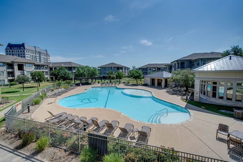 the preserve at ballantyne commons pool with chairs and apartment buildings