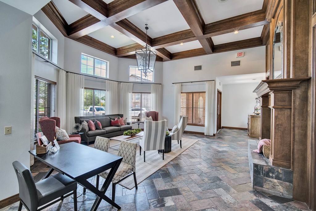 a living room with a table and chairs and a fireplace