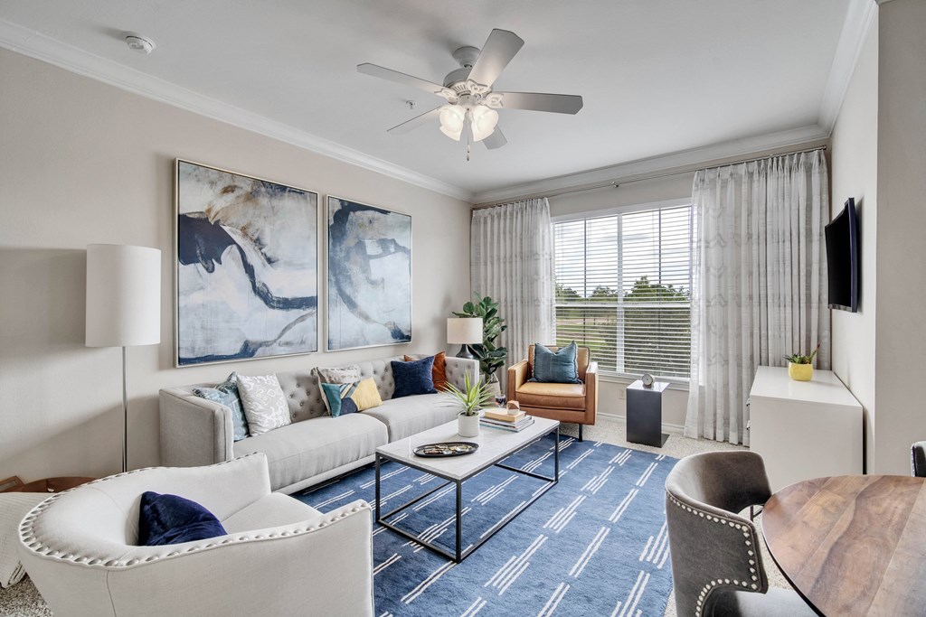 a living room with couches and chairs and a coffee table