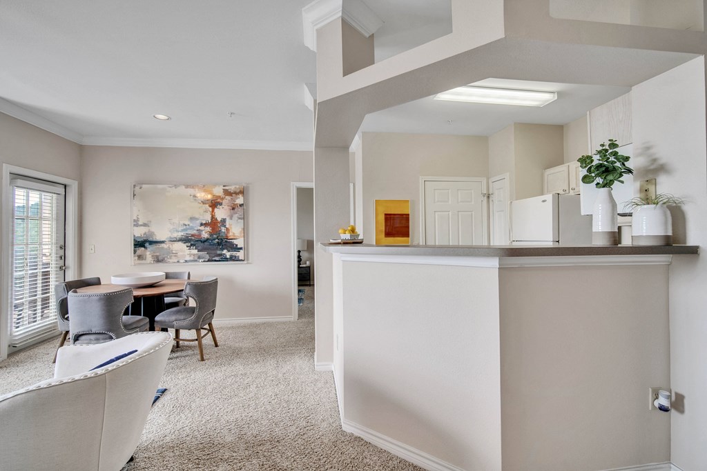 a living room with a kitchen and a dining room