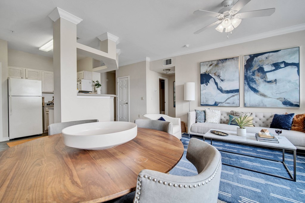 a living room with a dining room table and a kitchen