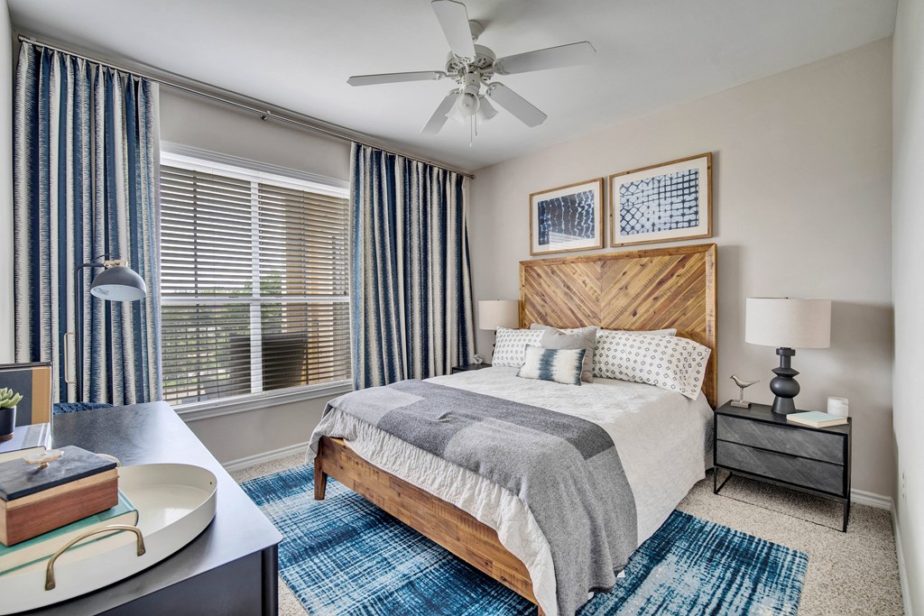 a bedroom with a bed and a ceiling fan