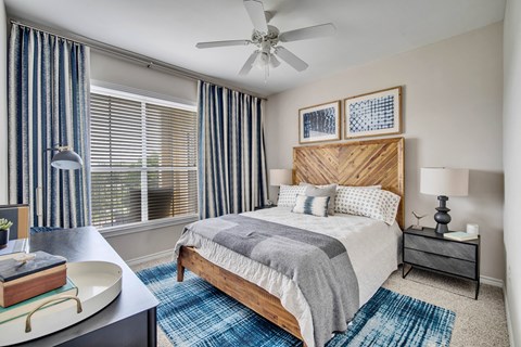 a bedroom with a bed and a ceiling fan