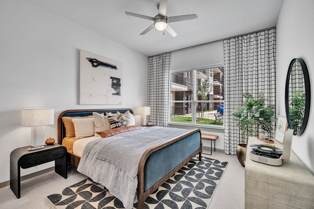 a bedroom with a bed and a ceiling fan
