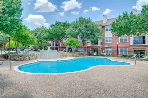 Resort style swimming pool with stone accents at Clearwater Creek Apartments, Texas