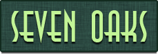Property entrance sign with green landscaping background at Seven Oaks Apts Apartments, Garland, Texas