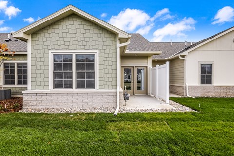 the front of a house with a driveway and grass