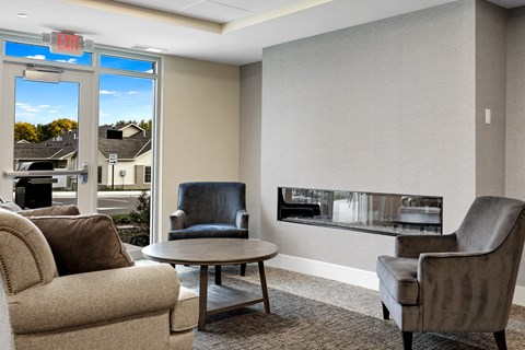 a living room with couches and chairs and a fireplace