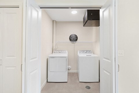 a washer and dryer in a laundry room with white appliances