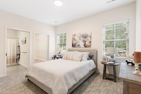 a bedroom with a bed and a door to a bathroom